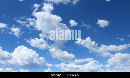 Puffy White Clouds in Blue Summer Sky Background Stock Photo