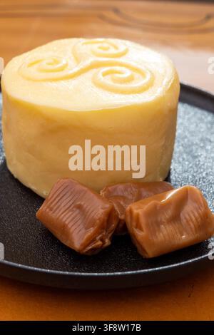 Creamy golden French handmade on farm butter from Brittany and caramel candies with sea salt flavor. Premium artisanal dairy product of Brittany. Stock Photo