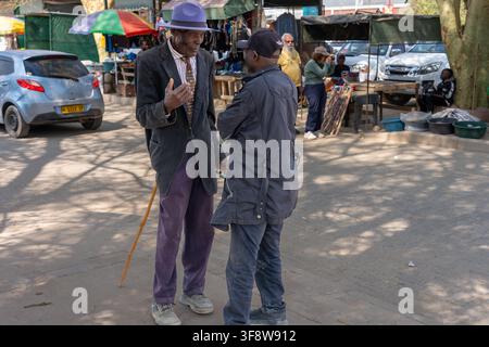 Two older men are chatting  at a local street market in Opuwo, Namibia. Stock Photo