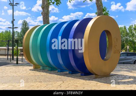 Jean Dubrana's colourful sculpture ("O" as Orléans), in Orléans France, brings contemporary art to a public square through layered circular forms. Stock Photo