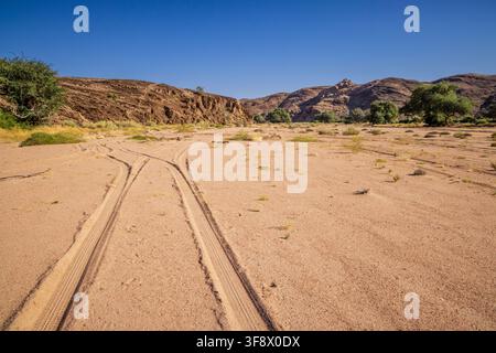 Tyre tracks on the dried up Ugab river at Brandberg mountain, Namibia, Africa Stock Photo