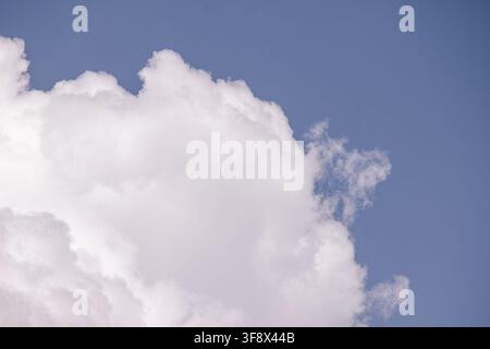 Large white cumulus cloud against a blue sky with copy space Stock Photo