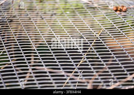 Close-up of a wire mesh screen used to sift sand, separating it from the pebbles Stock Photo