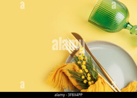 Romantic spring table setting with mimosa for wedding or Valentine concept Stock Photo