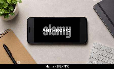 August 13, 2026: In this photo illustration, a horizontally placed smartphone displays the Anthropic AI app logo on a minimalist office desk, in Guwahati, India on 13 August 2026. (Credit Image: © David Talukdar/ZUMA Press Wire) EDITORIAL USAGE ONLY! Not for Commercial USAGE! Stock Photo