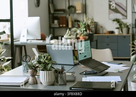 Empty Modern Office Workspace with Laptops Showing Financial Data Stock Photo