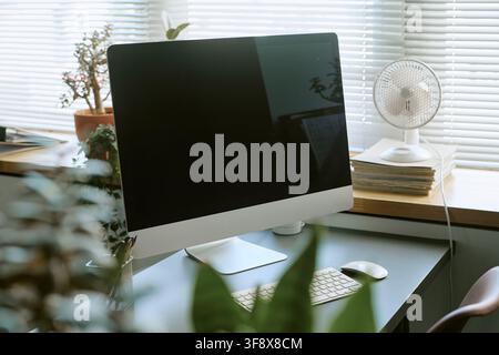 Empty Computer Screen on Desk in Modern Office Workspace Stock Photo