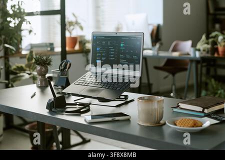 Laptop Displaying Call Center Software on Desk in Modern Office Stock Photo