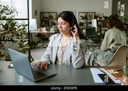 Diverse Female Helpdesk Agents Answering Calls in Modern Office Stock Photo
