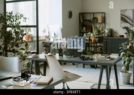 Empty Modern Office Workspace with Laptop Showing Business Dashboard Stock Photo