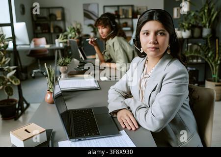 Portrait of Diverse Female Helpdesk Agents Working on Laptops Stock Photo