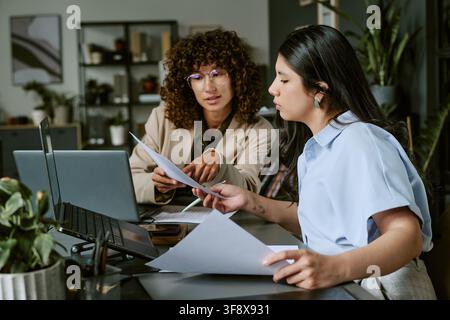 Diverse Women Collaborating on Business Project in Modern Office Stock Photo