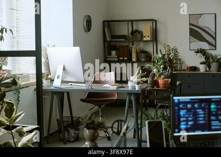 Empty Modern Office Workspace with Computer and Green Plants Stock Photo