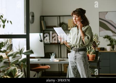 Young Woman Working in Call Center and Consulting Clients Stock Photo