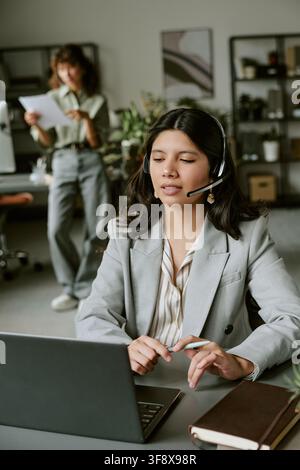 Diverse Women Working in Call Center Using Headsets Stock Photo