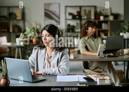 Two Diverse Women Working in Modern Call Center Stock Photo