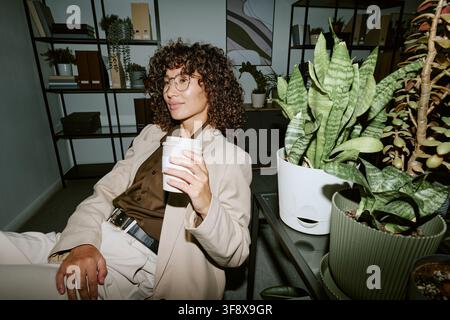 Businesswoman Working in Modern Office Having Coffee Break Stock Photo