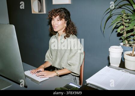 Young Woman Working in Call Center Using Computer Stock Photo
