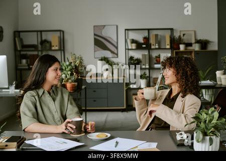 Diverse Women Colleagues Having Coffee Break in Modern Office Stock Photo