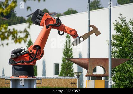 Industrial robot sculpture symbolizing automation and the use of robotics for heavy-duty work. Stock Photo