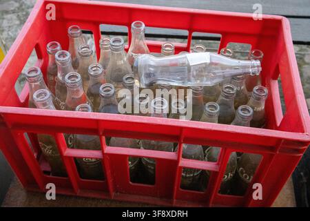 Clear glass bottles in a red crate Stock Photo