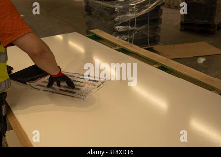 Worker pointing at store layout blueprint plan Stock Photo