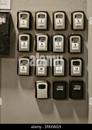 Buenos Aires, Argentina - March 29, 2026: Rows of numbered combination key lockboxes mounted on an interior wall at Babel accommodation for self-servi Stock Photo