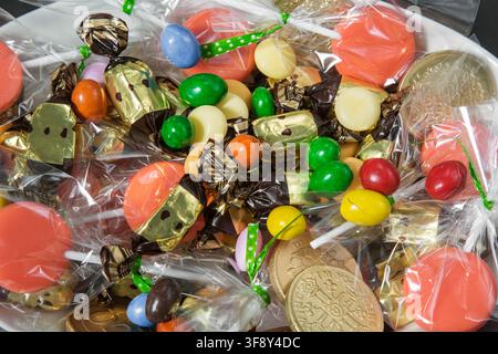 a scattering of various sweets on a black background, preparing for Halloween Stock Photo