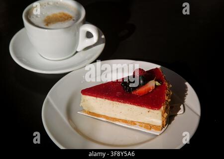 vanilla cheesecake with berries on a white plate sunny photo. High quality photo Stock Photo