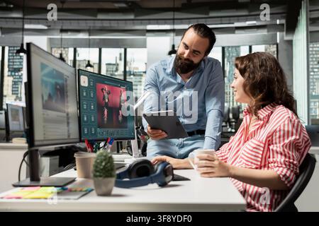 Agency employees develop visual content using AI generative models with virtual assistant, generating images and editing photos to produce editorial materials for catalog. Creative office studio. Stock Photo