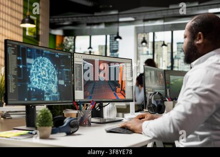 Black worker creating fantasy video game with AI neural networks systems, using advanced development software. Engineer working with programming tools and gaming assets, building virtual world. Stock Photo