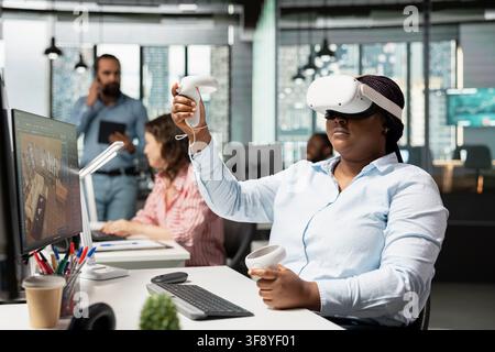 VR headset simulation, architectural floor plan, designing apartment layout and blueprint on PC with 3D modeling software. Woman employee using CAD virtual tools and VR glasses. Stock Photo
