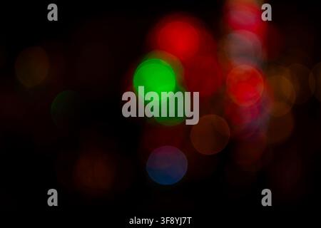Colorful festive bokeh lights on dark background with copy space Stock Photo