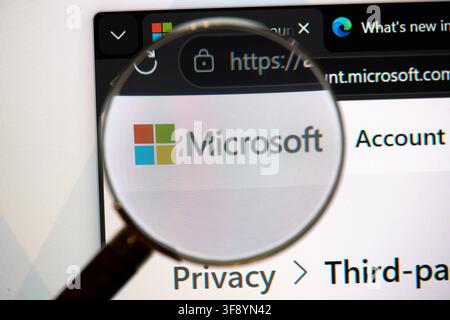 CARROLLTON, TX, USA - AUGUST 01, 2026: A magnifying glass focuses on the Microsoft logo displayed on a computer screen. Microsoft is a leading technol Stock Photo