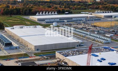 Expansive data center campus showing multiple buildings and rows of server cooling units Stock Photo