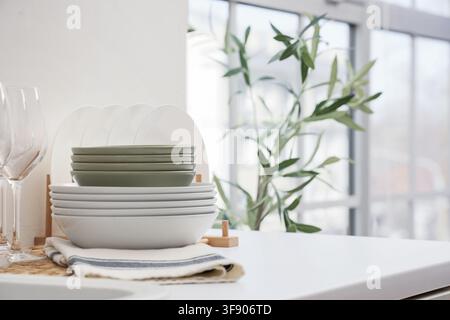 Stack of clean dishes on counter in kitchen Stock Photo