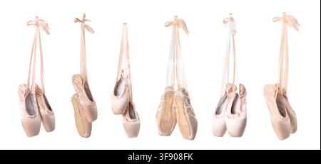 Multiple pairs of pink satin ballet pointe shoes with ribbons hanging gracefully, isolated on a clean white background, the elegant dance footwear is Stock Photo