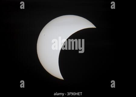 Shortly in front of sunset, the sun darkens during a solar eclipse, seen here in Berlin on 12/08/2026 Stock Photo
