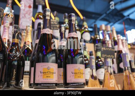 Penang, Malaysia - April 15, 2025: In a colorful retail space, several bottles of Veuve Clicquot Rose champagne are prominently represented in addit Stock Photo