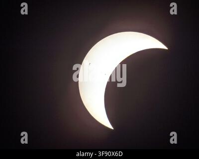 Sun during partial solar eclipse, still slightly covered by lunar shadow, Braunschweig, Lower Saxony, Germany Stock Photo