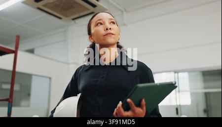 Woman, architect or thinking with tablet on construction site for security or safety inspection. Female person, contractor or civil engineer checking Stock Photo