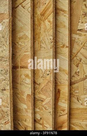 Vertical closeup shot of stacked OSB oriented strand board panels showing side edges and textures Stock Photo