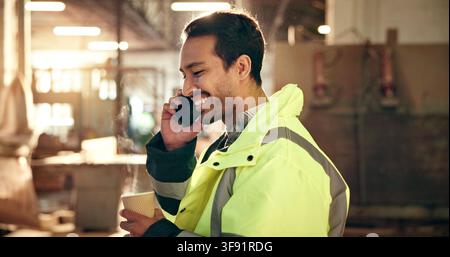 Carpenter, coffee and man in workshop for phone call, production update and talking on break. Construction, contractor and person on cellphone for Stock Photo