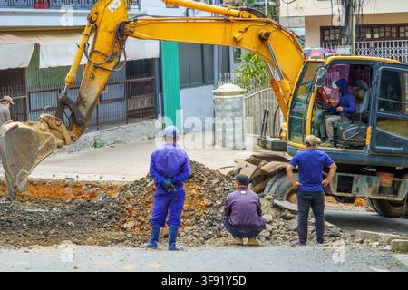 Construction workers inspecting excavation site. Stock Photo