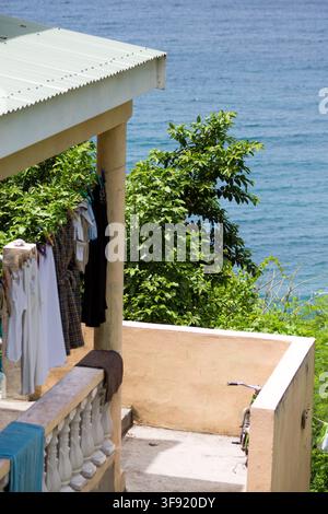 Laundry drying on a Caribbean balcony overlooking the sea. Stock Photo