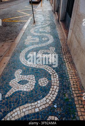 Traditional Portuguese mosaic sidewalk with wave pattern Stock Photo