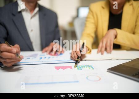 Business Team Analyzing Financial Charts in Meeting Stock Photo