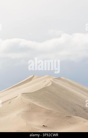 Pale sand dunes under a soft cloudy sky Stock Photo