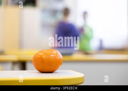 Bright citrus fruit placed on a tabletop in a primary school setting, conveying a wholesome lifestyle and focus on nutrition for children in an educat Stock Photo