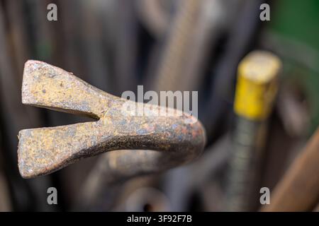 Rusty crowbar head close-up, displaying corrosion and signs of heavy use, representing industrial tools, demolition, and renovation equipment Stock Photo